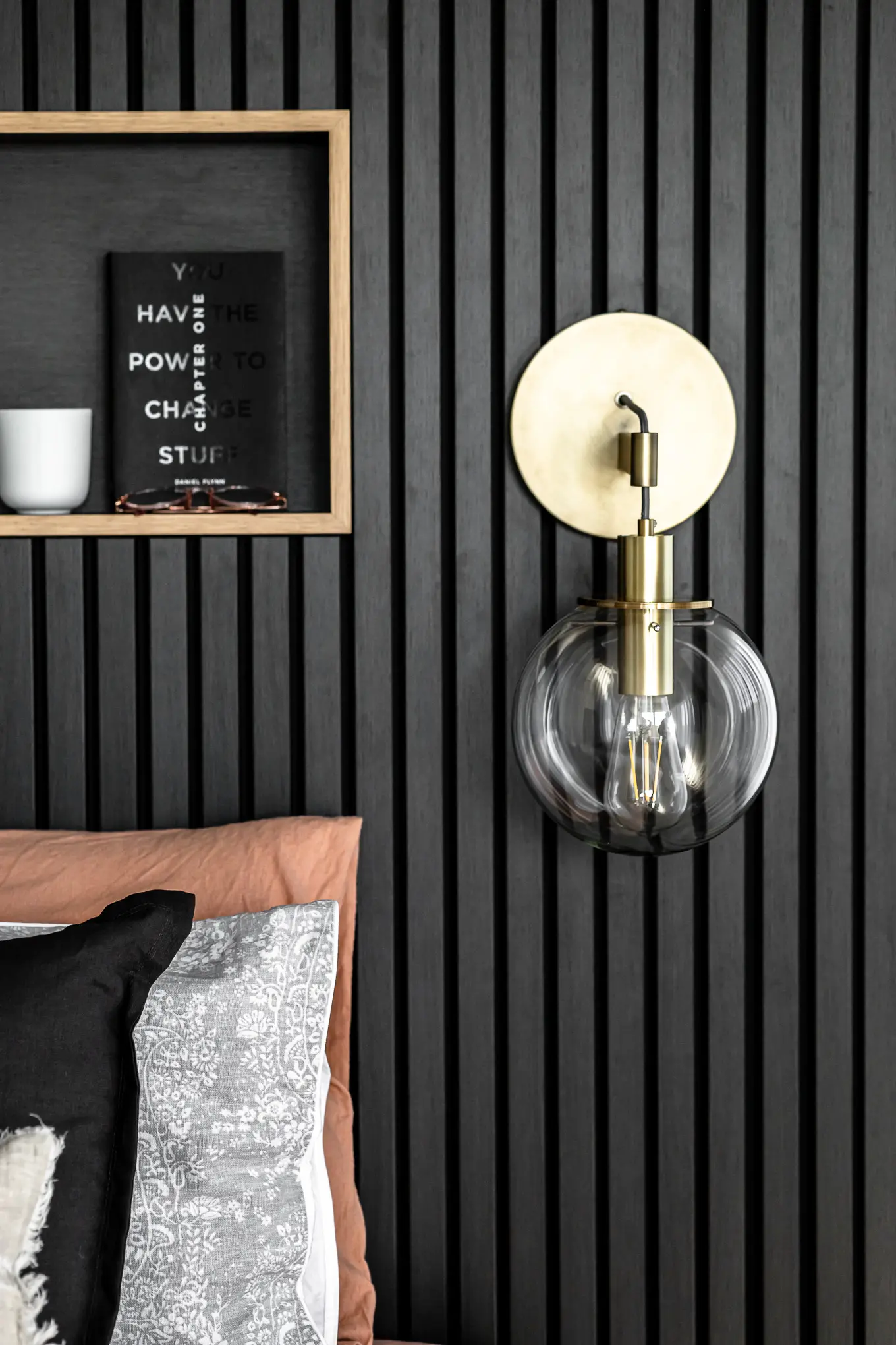 Elegant interior design of a bedroom in Hobart featuring a stylish wall-mounted light fixture, designed by Cove Interior Design.