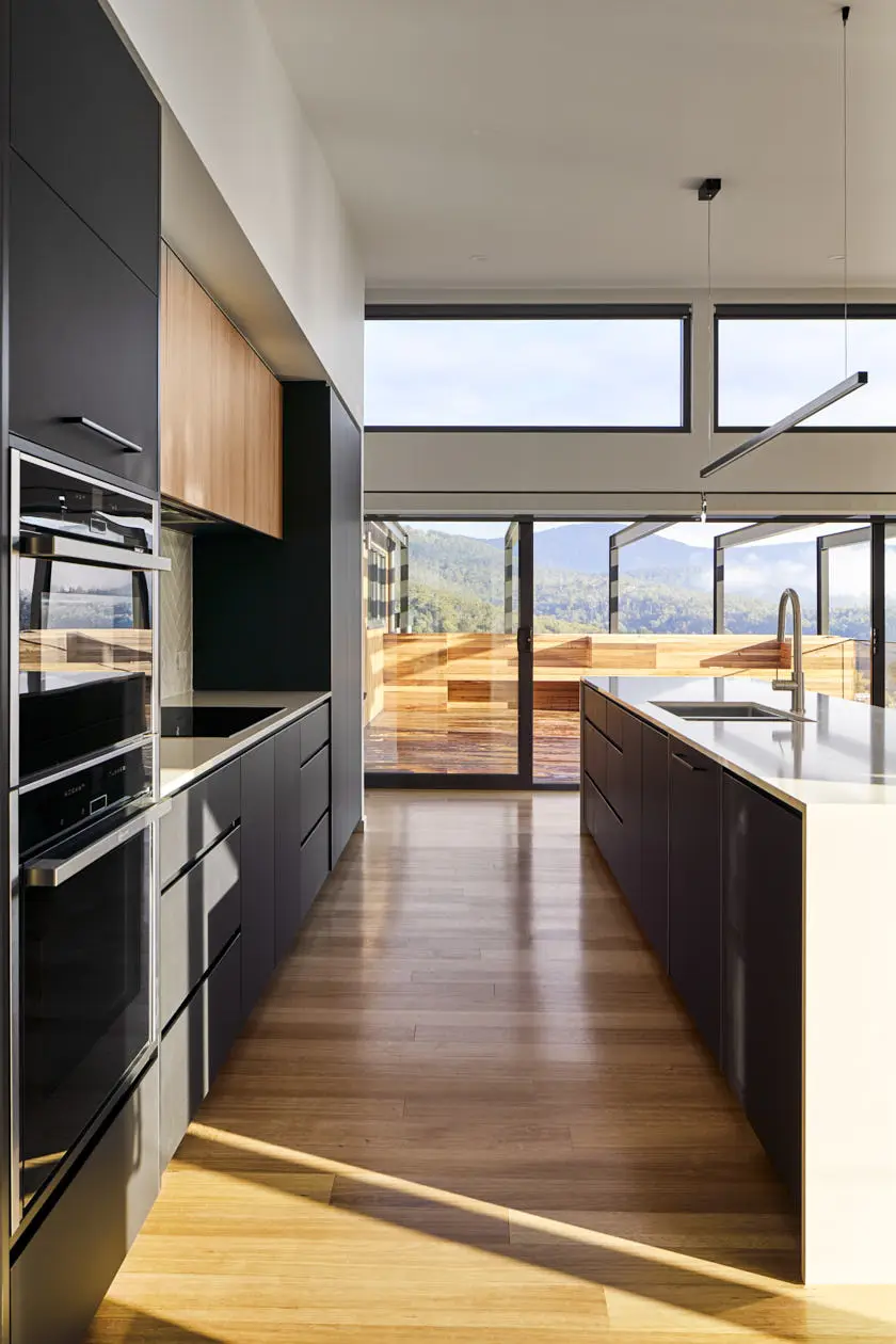 Interior designer in Hobart creates a sleek, modern kitchen with expansive views, featuring high-end appliances and elegant wood accents.